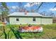 A single-story home with light green siding and a brick chimney sits on a grassy lot at 290 Collie Rd, Castalia, NC 27816