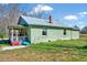 A single-story home has light green siding, a metal roof, and a covered porch at 290 Collie Rd, Castalia, NC 27816