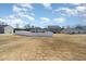 Long view of backyards in neighborhood with white fences and dry grass at 2902 Cullens Dr, Graham, NC 27253