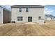 Back of house with sliding glass door, small patio and dry grass at 2902 Cullens Dr, Graham, NC 27253