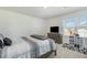 Bright bedroom featuring a bed, dresser with a TV, a window, and playful decor at 2902 Cullens Dr, Graham, NC 27253