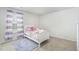 Charming bedroom with a white bed, colorful bedding, and striped curtains at 2902 Cullens Dr, Graham, NC 27253