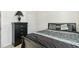 Bedroom featuring a black dresser, lamp, and a bed with patterned bedding and decorative pillows at 2902 Cullens Dr, Graham, NC 27253