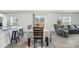Open concept dining area with barstool seating, hardwood floors, and view to backyard at 2902 Cullens Dr, Graham, NC 27253