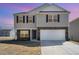 Charming two-story home with stone accents, attached two-car garage, and well-maintained lawn at 2902 Cullens Dr, Graham, NC 27253