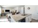 Bright open-concept kitchen with granite counters and stainless steel dishwasher overlooking living and dining areas at 2902 Cullens Dr, Graham, NC 27253