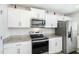 Well-lit kitchen showcases stainless steel appliances, granite countertops, and ample white cabinetry at 2902 Cullens Dr, Graham, NC 27253