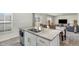 Bright kitchen featuring granite countertops, a stainless steel sink, and an open view to the living area at 2902 Cullens Dr, Graham, NC 27253