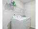 Functional laundry room with modern washer and dryer, and storage shelf at 2902 Cullens Dr, Graham, NC 27253