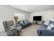 Cozy living room with neutral walls, hardwood floors, large window, and comfortable seating at 2902 Cullens Dr, Graham, NC 27253