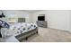 Bright main bedroom features neutral carpet, coordinating furniture, and plenty of natural light at 2902 Cullens Dr, Graham, NC 27253