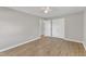 Light-filled bedroom with wood-look flooring and a double-door closet at 2914 Old Stage N Rd, Coats, NC 27521