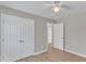 Bedroom with wood floors, ceiling fan, and closets at 2914 Old Stage N Rd, Coats, NC 27521