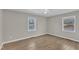 Bright bedroom features wood-look flooring, two windows, and a ceiling fan at 2914 Old Stage N Rd, Coats, NC 27521