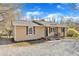Angle view of house showing the tan siding, shutters and front porch with chairs at 2914 Old Stage N Rd, Coats, NC 27521