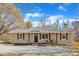 Charming home features tan siding, shutters, a covered front porch and well maintained landscaping at 2914 Old Stage N Rd, Coats, NC 27521
