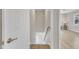 Hallway with wood-look flooring next to a carpeted staircase at 2914 Old Stage N Rd, Coats, NC 27521