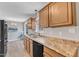 Kitchen with stainless steel sink, dark appliances, wood cabinets, and dining area at 2914 Old Stage N Rd, Coats, NC 27521