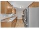 Kitchen featuring stainless steel refrigerator, wood cabinets, and wood flooring at 2914 Old Stage N Rd, Coats, NC 27521