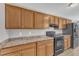 Kitchen with black appliances, laminate countertops, and wood cabinets at 2914 Old Stage N Rd, Coats, NC 27521