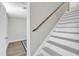 Stairway with painted treads and wooden handrail to lower level at 2914 Old Stage N Rd, Coats, NC 27521