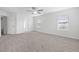 Spacious bedroom with neutral carpet, ceiling fan, and large windows for natural light at 3105 Marshlane Way, Raleigh, NC 27610