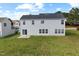 Back of the home with a well-maintained yard and sliding glass door at 3105 Marshlane Way, Raleigh, NC 27610
