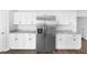 Bright kitchen featuring stainless steel refrigerator, sleek countertops, and white cabinets offering ample storage at 3105 Marshlane Way, Raleigh, NC 27610