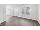Bright living room with modern gray vinyl floors, white walls, and large windows at 3105 Marshlane Way, Raleigh, NC 27610