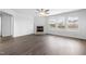 Cozy living room featuring a fireplace, large windows, and modern vinyl floors at 3105 Marshlane Way, Raleigh, NC 27610