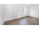 Bright living room with modern gray vinyl floors, white walls, and large windows at 3105 Marshlane Way, Raleigh, NC 27610