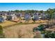 Beautiful aerial view of the property showcasing backyard playset and peaceful pond in a residential neighborhood at 3574 Johnson Grant Dr, New Hill, NC 27562