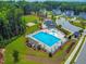 Aerial view of community pool, playground, and clubhouse with ample parking at 3574 Johnson Grant Dr, New Hill, NC 27562