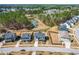 Neighborhood aerial view showcasing the community, landscaping, backyards, mature trees, and a neighborhood pond at 3574 Johnson Grant Dr, New Hill, NC 27562