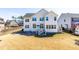 The back exterior features a yard and deck with stairs, a small storage shed, and a view of the neighborhood at 3574 Johnson Grant Dr, New Hill, NC 27562