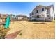 Private backyard with mature trees, playset, and ample space for recreation and outdoor enjoyment at 3574 Johnson Grant Dr, New Hill, NC 27562