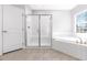 Well-lit bathroom with shower, bathtub and tiled floor at 3574 Johnson Grant Dr, New Hill, NC 27562