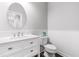 Bathroom features a white vanity with a rectangular sink and toilet against the wainscotted wall at 3574 Johnson Grant Dr, New Hill, NC 27562