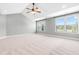 Vaulted ceiling bedroom with two large windows and carpeted floor at 3574 Johnson Grant Dr, New Hill, NC 27562