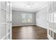 The bedroom boasts hardwood floors, neutral walls, large windows and classic French doors at 3574 Johnson Grant Dr, New Hill, NC 27562