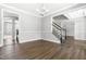 Elegant dining room featuring hardwood floors, decorative molding, chandelier, and open access to other rooms at 3574 Johnson Grant Dr, New Hill, NC 27562