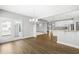 Dining room with hardwood floors, bright lighting, and a view of the kitchen with granite countertops at 3574 Johnson Grant Dr, New Hill, NC 27562
