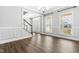 Spacious foyer with hardwood floors, wainscoting, staircase, and two large windows, offering an inviting entrance at 3574 Johnson Grant Dr, New Hill, NC 27562