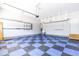 Spacious garage with an epoxy floor, ample storage, and utility sink at 3574 Johnson Grant Dr, New Hill, NC 27562