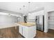 Bright kitchen featuring granite counters, a stainless refrigerator, and a walk-in pantry at 3574 Johnson Grant Dr, New Hill, NC 27562