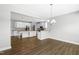 Open-concept kitchen and dining area with white cabinets, an island, and hardwood floors at 3574 Johnson Grant Dr, New Hill, NC 27562