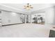 Bright living room with open access to a modern, eat-in kitchen with white cabinets and stainless appliances at 3574 Johnson Grant Dr, New Hill, NC 27562
