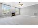 Bright living room featuring carpet, a fireplace, and large windows that provide an abundance of natural light at 3574 Johnson Grant Dr, New Hill, NC 27562
