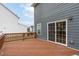 Cozy back deck with sliding glass door, gray siding, and wooden railing at 3727 Horton Hill Dr, New Hill, NC 27562