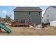 Large backyard with deck, patio seating area, fire pit, and green slide at 3727 Horton Hill Dr, New Hill, NC 27562